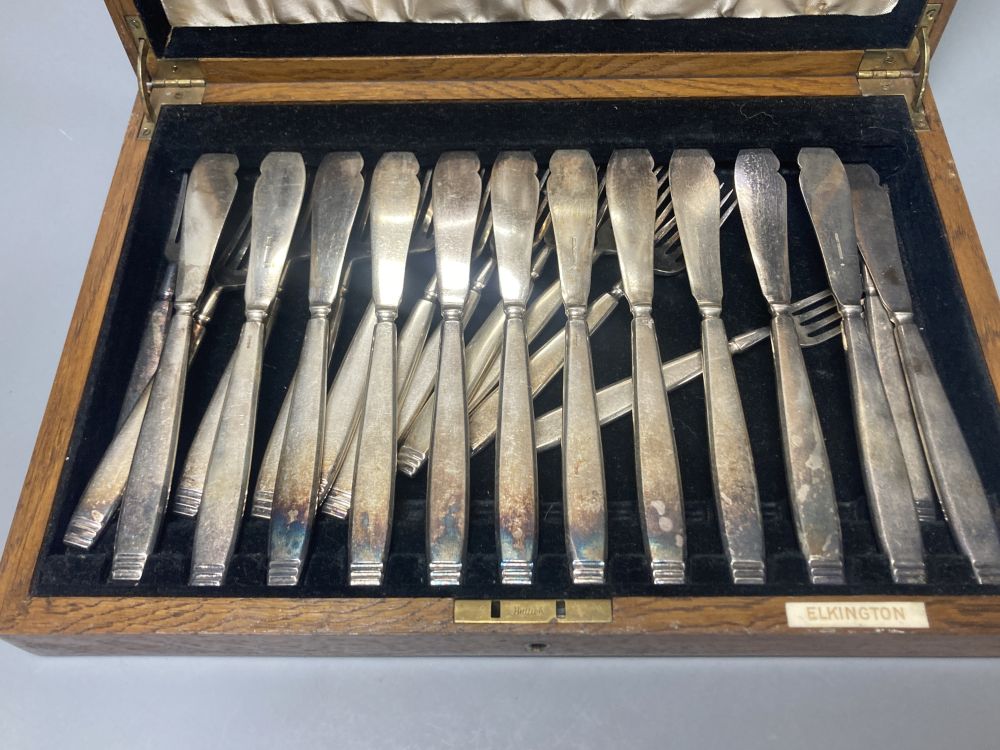 A cased Elkington plated canteen of Rochester-pattern cutlery, near complete, and similar oak cased set of twelve fish knives and forks